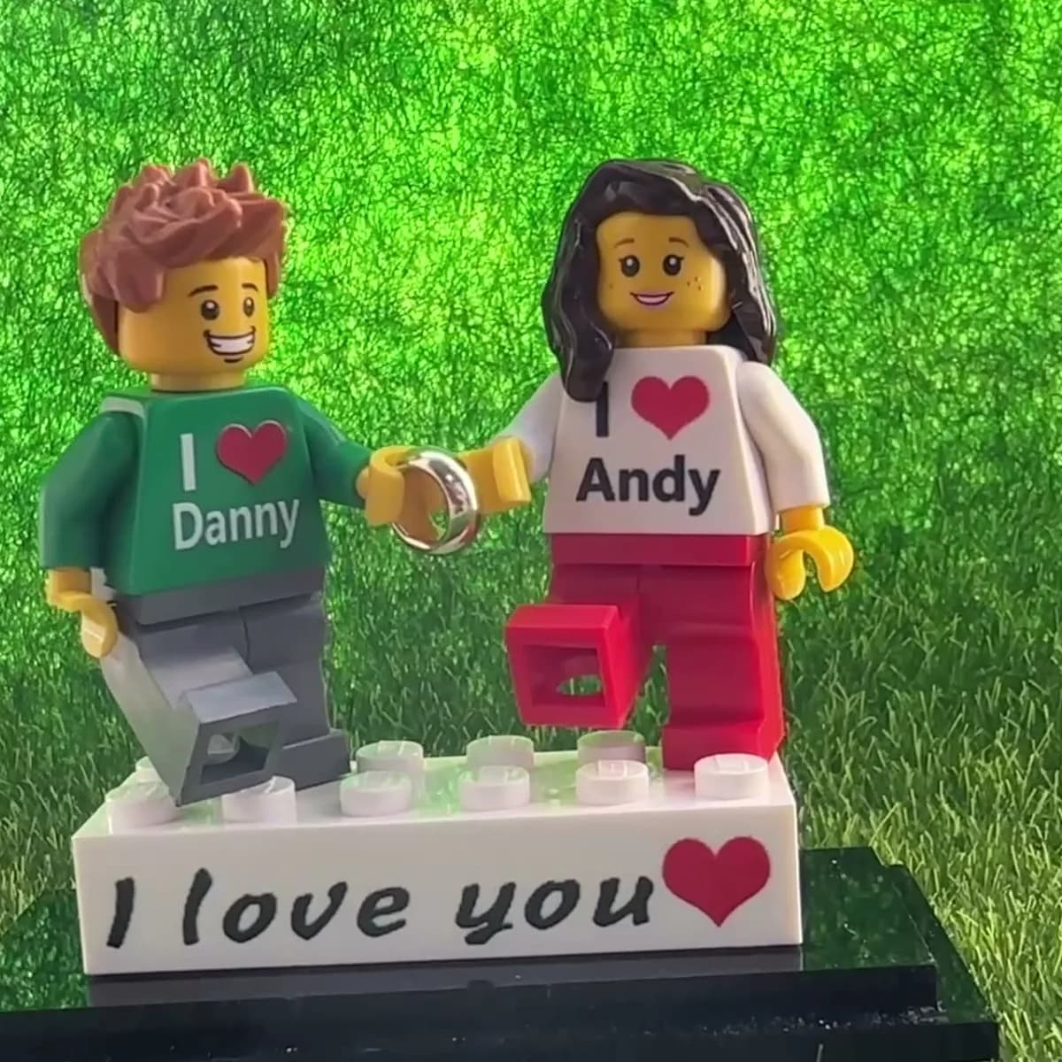 Acrylic display case with custom brick figure couple, seen from another angle